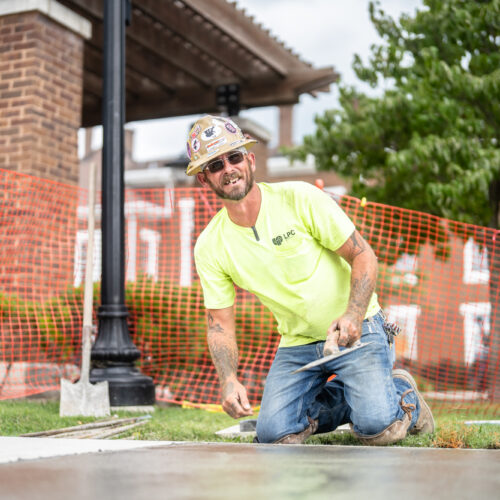 A contractor smooths over cement in Kentuckiana